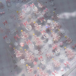 Macro detail of 3D embossed shell light Christmas nail stickers with tree and snowflake patterns