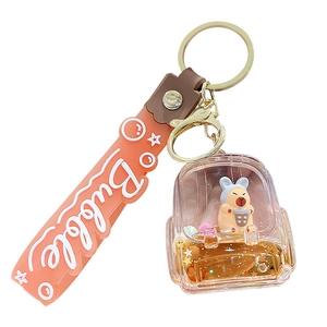 Orange milk tea cup keychain with floating liquid sand and cute animal charm for bags