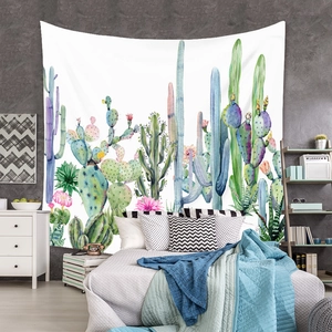 Detail of bohemian watercolor cactus forest wall tapestry in a cozy bedroom setup