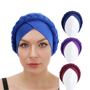 Detail view of twisted braid turban hats in various colors including blue and purple shades