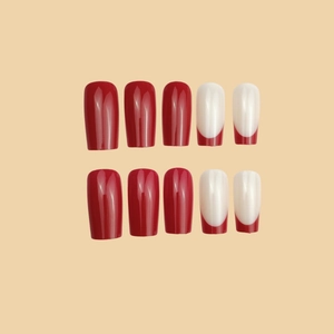 Glossy red and white French manicure press-on nails in medium-long coffin shape