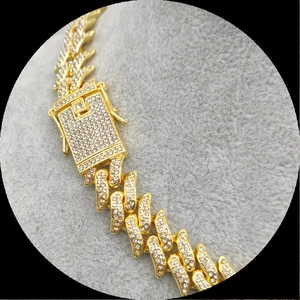 Macro shot of gold-plated cuban chain links with micro-paved sparkling crystals