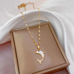 Titanium steel gold dolphin necklace with white shell inlay on silk background