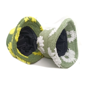 Furry winter bucket hats with wavy patterns in olive and light green plush fabric