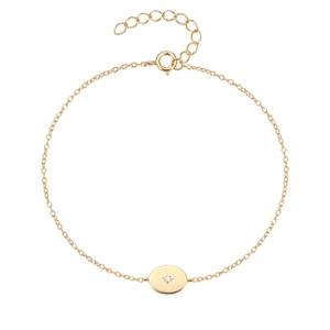 Detail of adjustable gold chain bracelet with starburst engraved oval pendant