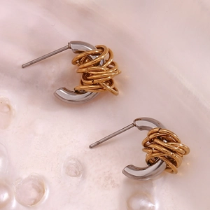 Macro shot of two-tone C-shape earrings with gold wire wrapped on silver stainless steel