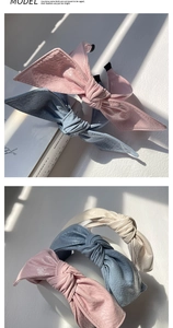 Detail of retro PU leather bow headbands in pink, blue, and cream with glossy texture
