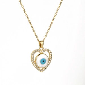 Golden heart necklace with evil eye pendant and clear gemstones on white background