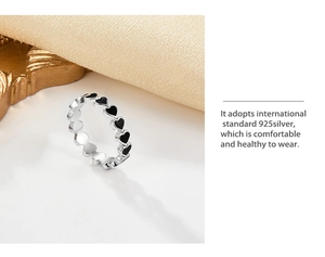 Macro shot of 925 sterling silver ring featuring multiple black enamel heart shapes