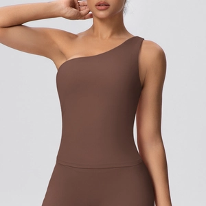 Detail of the chocolate brown sports bra featuring a one-shoulder neckline and matte fabric