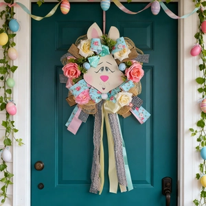 Handmade Easter bunny wreath with colorful roses and ribbons on a blue front door