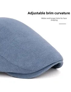 Detail of blue corduroy beret featuring a foldable wide brim for face-shaping effect