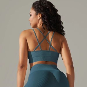 Detail view of criss-cross back straps and ribbed texture on the blue sports bra