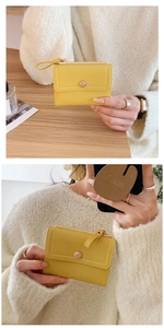 Detailed views of a compact yellow tri-fold wallet featuring a snap closure and zipper pocket