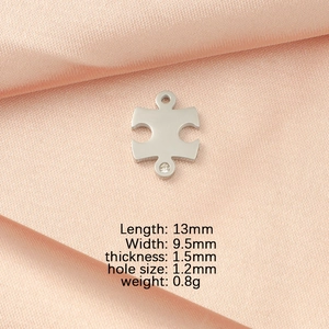 Detail of silver puzzle pendant with crystal inlay on pink silk including product dimensions
