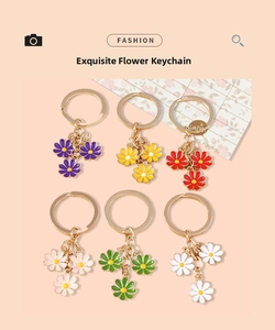 Detailed close-up of colorful daisy flower keychains with golden metal ring and bell