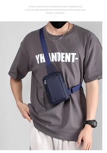 Detail of dark blue waterproof nylon chest bag featuring adjustable strap and zipper closure