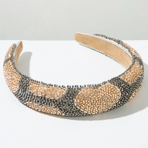 Detail of hand-sewn metallic beads in wave patterns on a wide padded headband