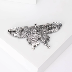 Retro butterfly alloy brooch with intricate silver-tone metal texture and secure back pin