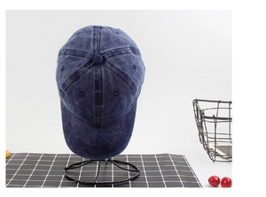 Detail shot of navy blue washed denim baseball cap featuring classic six-panel design