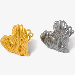 Detail of gold and silver heart-shaped adjustable rings with textured finish