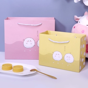 Süße rosa und gelbe Geschenktüten mit Cartoon-Schafen und japanischem Schriftzug