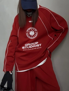 Detail of burgundy oversized tracksuit with white piping and chest printed logo