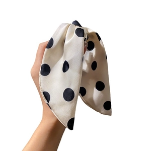 Polka dot silk bow hair claw clip in creamy white finish for elegant hairstyles
