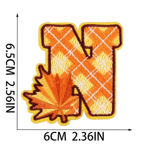 Detail of letter N embroidery patch with autumn maple leaf design and dimensions