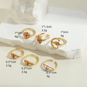 Gold evil eye ring set with zirconia and drip oil finish on white textured stone