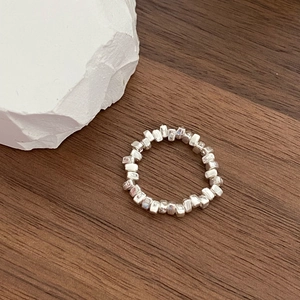 Detailed view of silver irregular cube beads on an elastic string minimalist ring