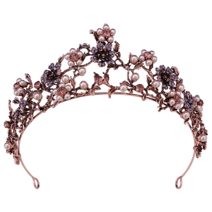 Detailed view of bronze bridal crown with purple crystals and pearls in floral design
