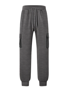 Detail view of gray textured cargo pants with drawstring waist and pocket details
