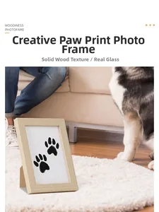 Solid wood pet paw print memorial photo frame with real glass on a soft white carpet
