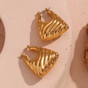 Detailed close-up of 18K gold plated trapezoid earrings with wavy texture