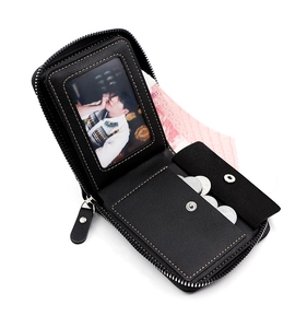 Detail view of the black leather wallet interior featuring card slots and a coin pocket