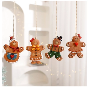 Detail of four gingerbread man ornaments hanging with twine strings for Christmas decor