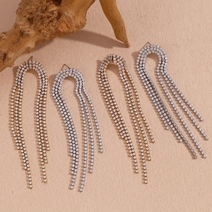 Close-up of long 18K gold and silver plated tassel earrings with micro-inlaid zircons