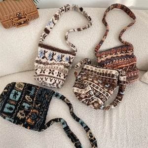 Close-up of four plush faux shearling tote bags with ethnic floral patterns on a sofa