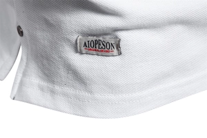 Detailed macro shot of white pique fabric and side vent of a premium cotton Polo shirt