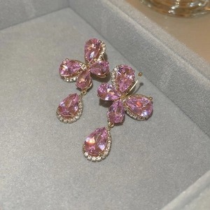 Macro shot of pink cubic zirconia butterfly earrings with water-drop charms and silver needles