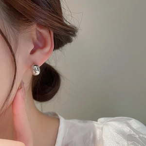 Minimalist silver bean stud earrings with high-gloss polished metallic finish for women