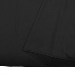 Detailed close-up showing the high-quality double-needle stitching on the black dress hem