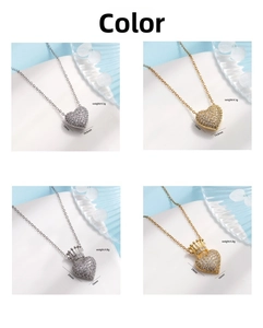 Detailed view of heart and crown pendant necklaces in gold and silver with zircon
