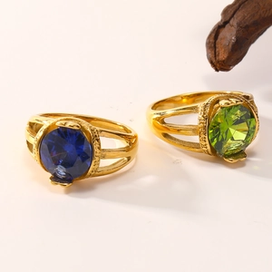 Close-up of 18K gold plated titanium rings featuring large oval blue and green zircons