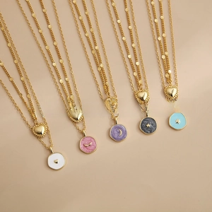Detail view of five double-layered 18K gold-plated necklaces with colorful drip oil pendants