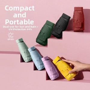 Macro shot of ultra-light foldable umbrellas in seven macaron colors on pink background