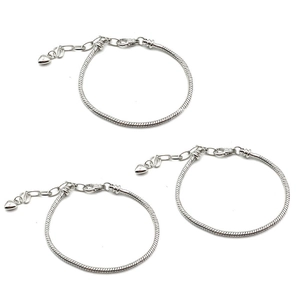 Three silver-colored snake chain bracelets with heart charms and extension links