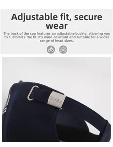 Detail of adjustable metal buckle on dark blue embroidered baseball cap with logo