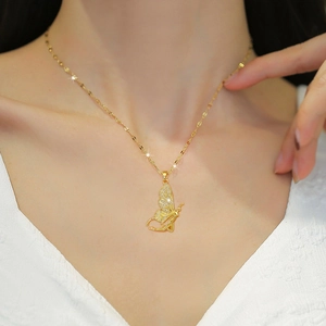 Elegant gold butterfly fairy necklace with sparkling cubic zirconia on a model